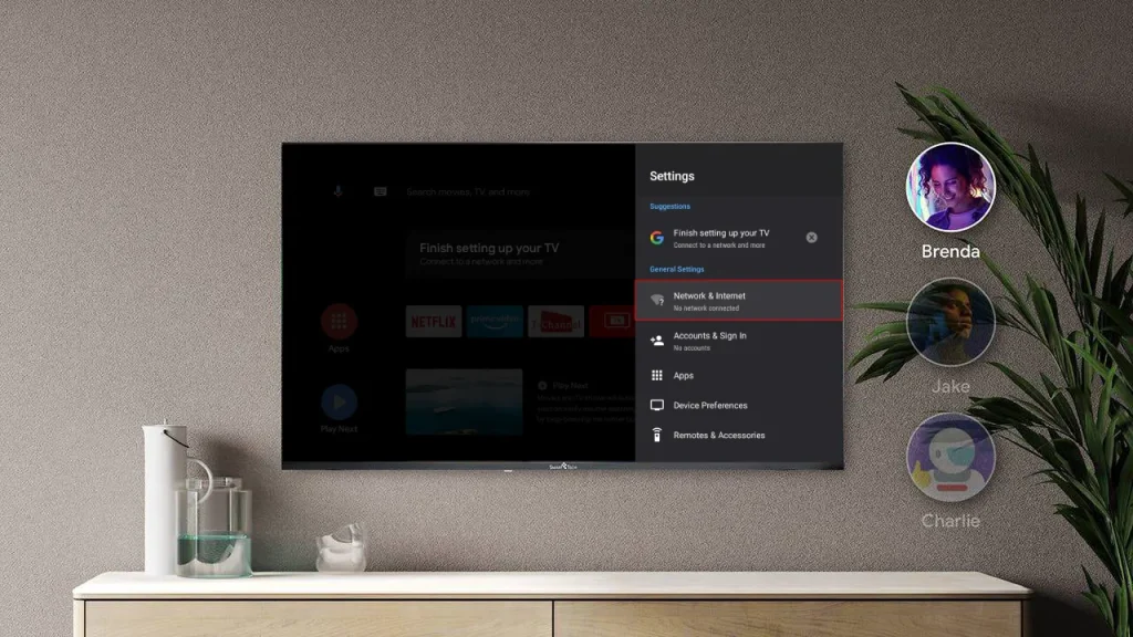 Et TV viser Indstillinger (Settings)-menuen for Google TV eller Android TV, hvor 'Network & Internet' er fremhævet. Brugerprofiler for Brenda, Jake og Charlie vises til højre.